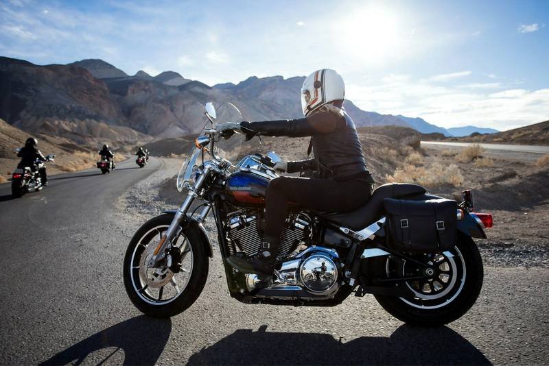 A rider on a cruiser motorcycle on a mountain road