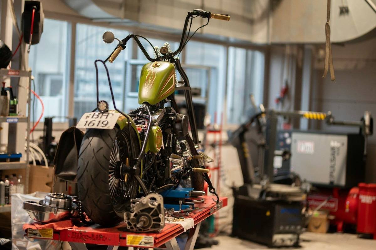 A custom motorcycle on a workshop bench