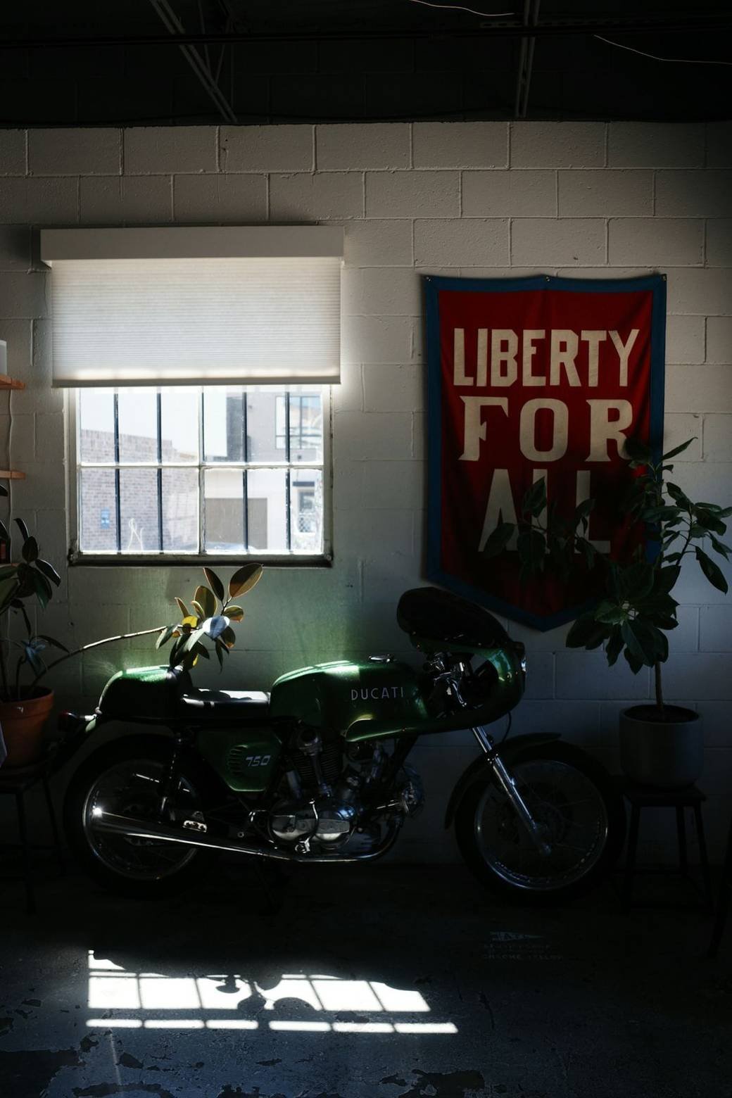 A vintage motorcycle parked in a dim garage