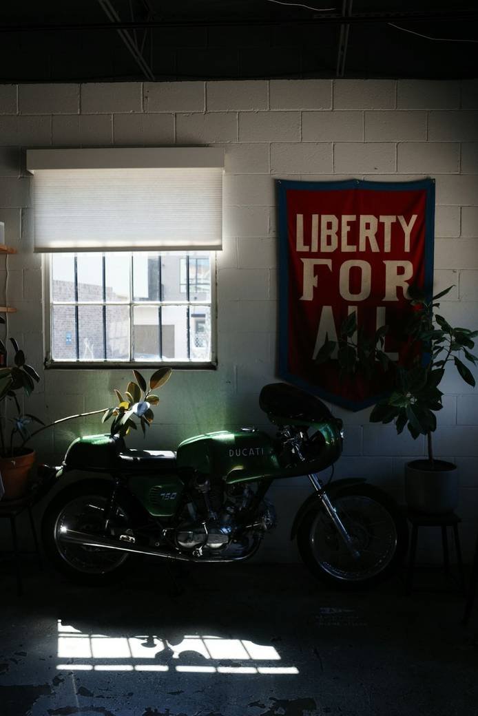 A vintage motorcycle parked in a dim garage